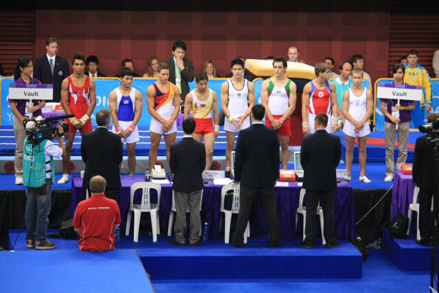 Male Gymnasts Presenting Themselves to the Judges