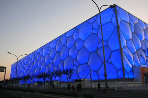 The National Aquatics Center Glows a Brilliant Blue at Night