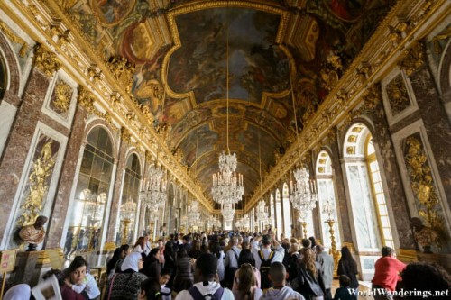 Numerous Tourists Crowd the Hall of Mirrors at the Palace of Versailles
