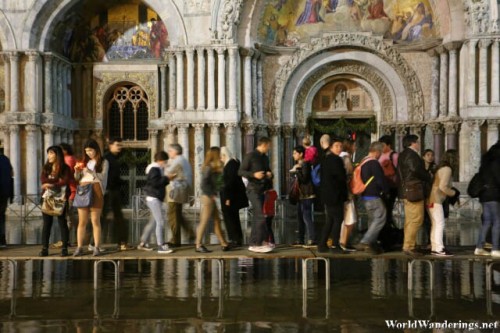 Visitors Walking on Elevated Platforms at the Piazza San Marco During Acqua Alta