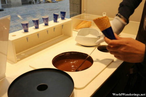 Pouring Some of the Rich Belgian Chocolate in to the Cone at Leonidas in Brussels