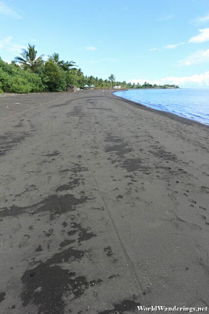 Black Volcanic Sand of Coron-coron Beach in Bacacay